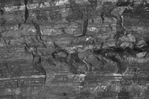 Stone texture. Gray striped stone. Minerals. Abstract dark pattern. Stock Photos