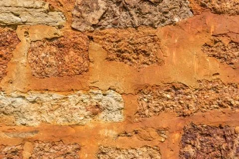 Stone texture of old ancient brick wall in sunny day. Modern luxury backgroun Stock Photos