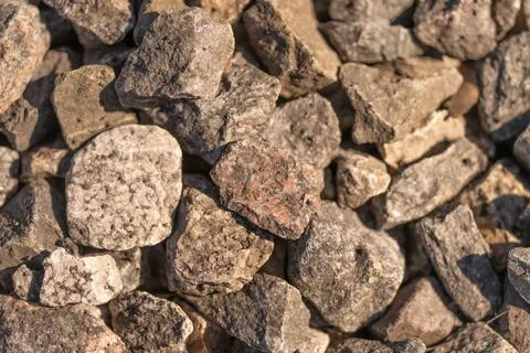 Stone texture overview. Weathered stone exhibiting erosion and granular surface Stock Photos