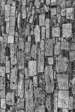 Stone texture vertical cobblestone wall weathered hard toned pattern Foto stock