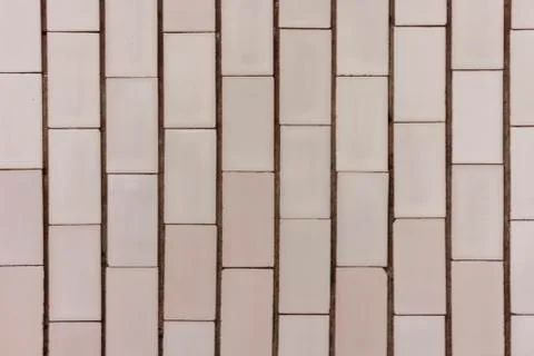 Stone texture – wall with white and rose facing tile in historic building Stock Photos