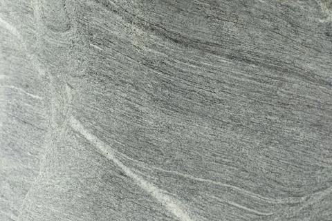 Stone texture with white splashes. Pattern on the rock. Stock Photos