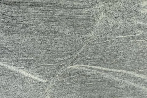 Stone texture with white splashes. Pattern on the rock. Stock Photos