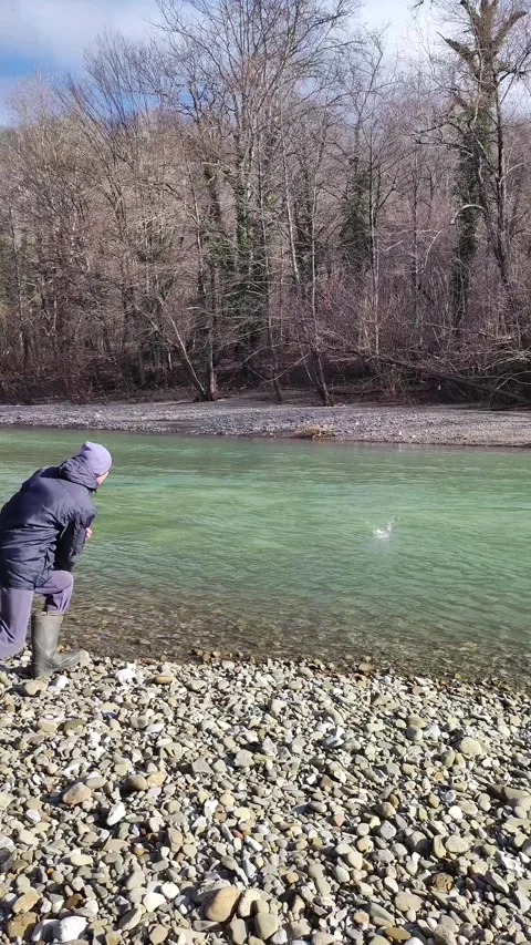 Stone Is Thrown To The Surface Of The River On Video Stock Footage 297932799
