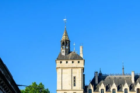 Stone tower and patterned spire under blue sky 스톡 사진
