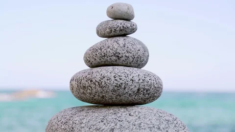 Stone tower on the beach against the azure sea. Cobblestone sculptures. Stock Footage 121316401
