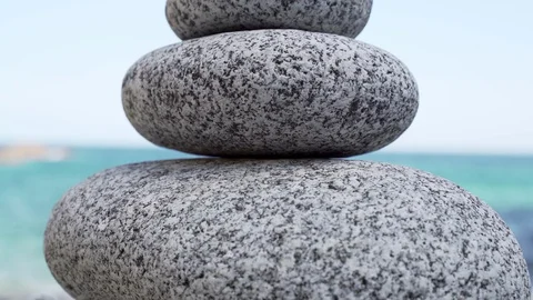 Stone tower on the beach against the azure sea. Cobblestone sculptures. Stock Footage 121803671