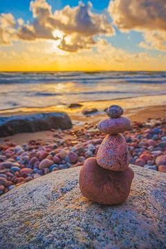 Stone tower on the beach with evening sunset light Stock Photos