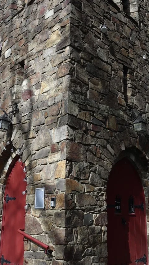 Stone tower corner of medieval castle with red doors Stock Footage 341906449