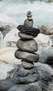 Stone tower next to a wild river Stock Photos