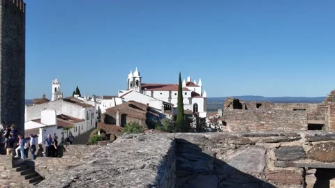 Stone tower overlooks whitewashed rooftops from monsaraz castle walls Stock Footage 309629359