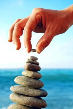 Stone tower on a pebble beach Stock Photos
