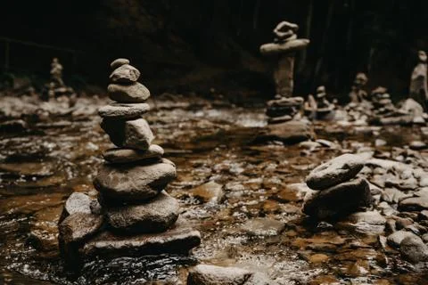 Stone tower pyramids on a mountain river Stock Photos