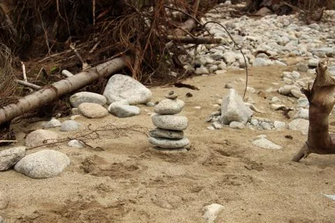 Stone tower in the river bed Stock Photos