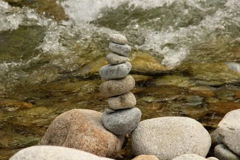 Stone tower in the river bed Stock Photos