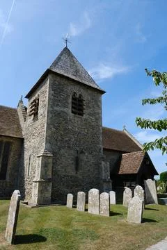 Stone Tower of St Peter and St Paul Church with Graveyard Tombstones Stock Photos