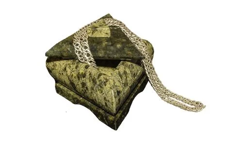 A stone, triangular casket made of a coil with a silver chain on a white isol Stock Photos