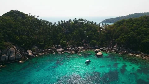 A stone tropical beach with clear turquoise water and reefs, suitable for diving Stock Footage 244976847