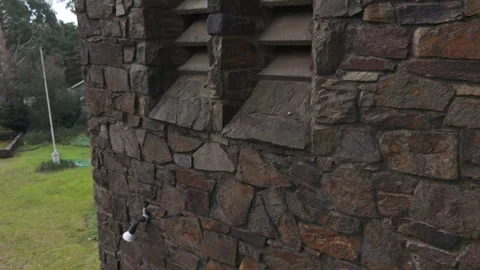 Stone turret wall of a rustic building panning downwards Stock Footage 341902809