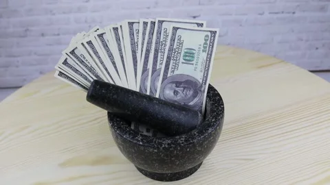 Stone vase with 100 dollar banknotes rotates on wooden table 스톡 동영상 144655155