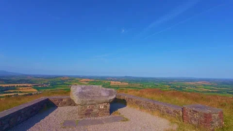 Stone viewpoint bench on top of hill looking over valley in Ireland Stock Footage 340435769