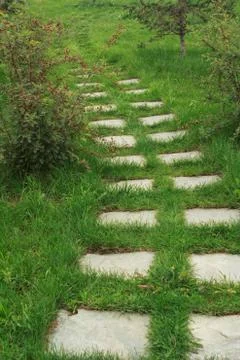 Stone walkway on the grass Stock Photos