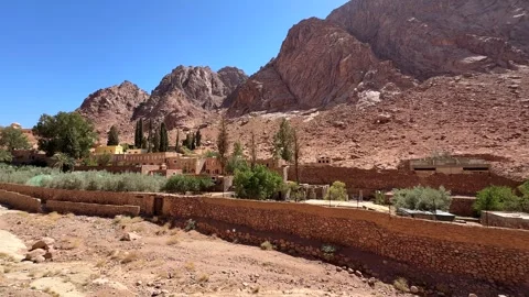 Stone wall and road approaching monastery in mountain valley Stock Footage 341452179
