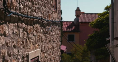Stone Wall and Rooftops in Narrow Old Town Street Vídeo Stock 335347503