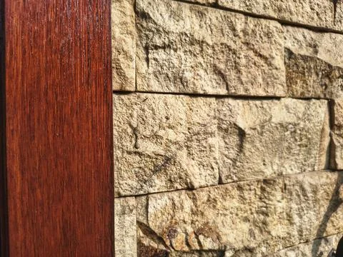 Stone wall and a smooth dark wood panel for background Stock Photos
