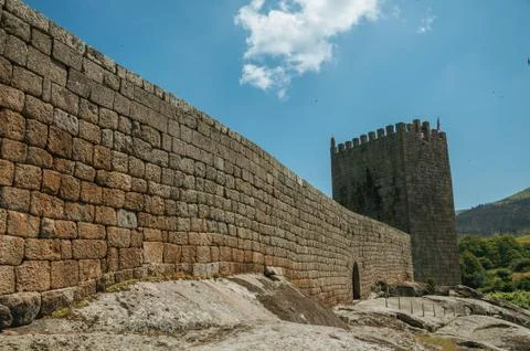 Stone wall and square tower from castle over rocky hill Stock Photos