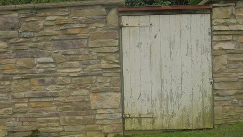 Stone wall and white barn doorway Stock Footage 95037958