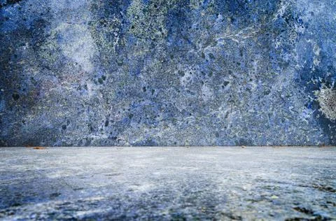 Stone wall angle in bluish tones with a lot of texture. Stock Photos