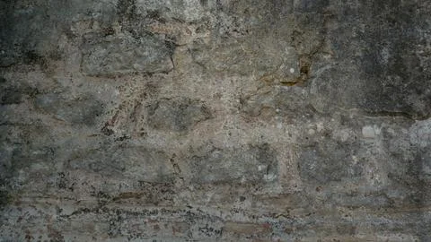 Stone wall background with ancient stonework. Close-up of a dilapidated stone Stock Photos