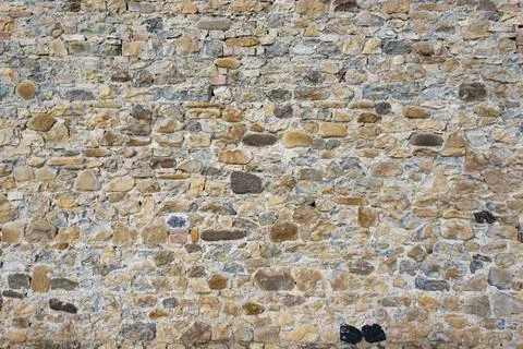 Stone wall background and ancient tuff, Tuscany in Italy Stock Photos