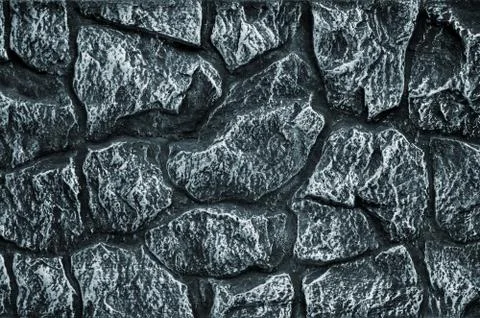Stone wall background - building feature. Texture of thick and strong wall of Fotos de archivo