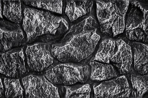 Stone wall background - building feature. Texture of thick and strong wall of Stockfoto's