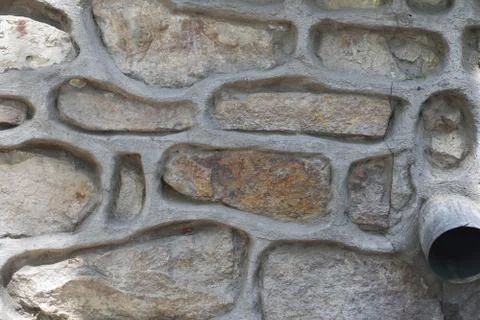 Stone wall background with cement lining seams Stock Photos