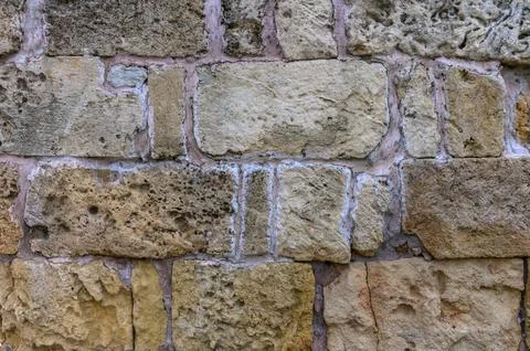 Stone wall, background. Light and shadow. Ancient town . Archaelogical site Stock Photos