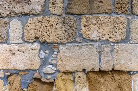 Stone wall, background. Light and shadow. Ancient town . Archaelogical site 1 Foto stock