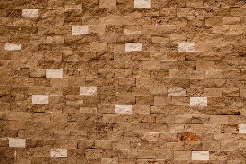 Stone wall as a background or texture. Beautiful shell bricks masonry. Stock Photos