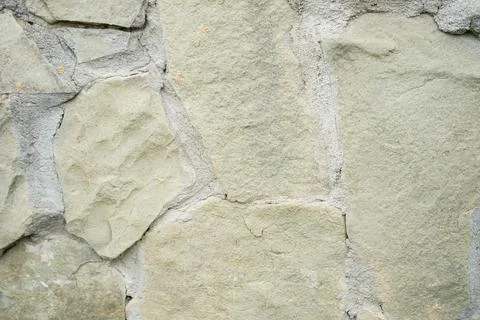 Stone wall as background or texture. The texture of the stone wall. Stock Photos