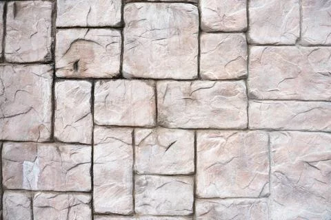 Stone wall as a background or texture. antique wall. pink stone. building. Stock Photos