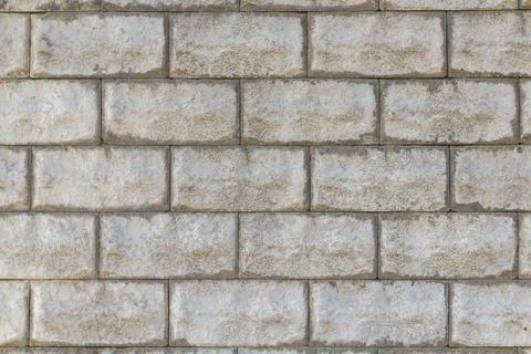 A stone wall as a background or texture. Masonry used as exterior wall claddi Stock Photos
