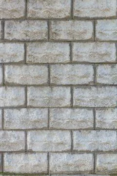 A stone wall as a background or texture. Masonry used as exterior wall claddi Stock Photos