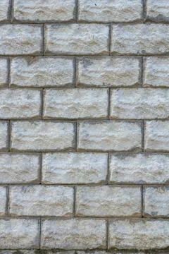 A stone wall as a background or texture. Masonry used as exterior wall claddi Stock Photos