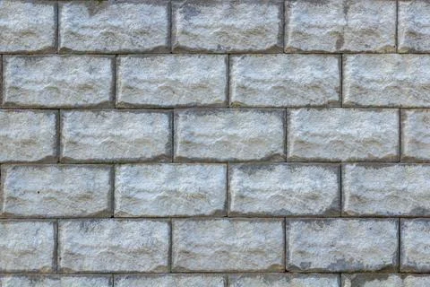 A stone wall as a background or texture. Masonry used as exterior wall claddi Stock Photos