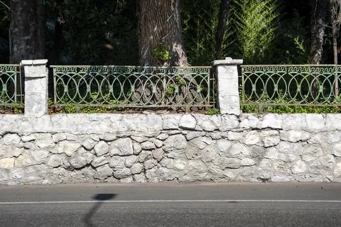 Stone wall background texture. Building facade, High fence made of stone bloc Stock Photos