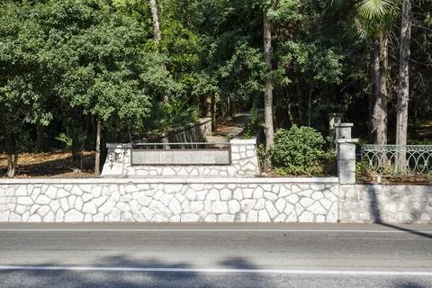 Stone wall background texture. Building facade, High fence made of stone bloc Stock Photos