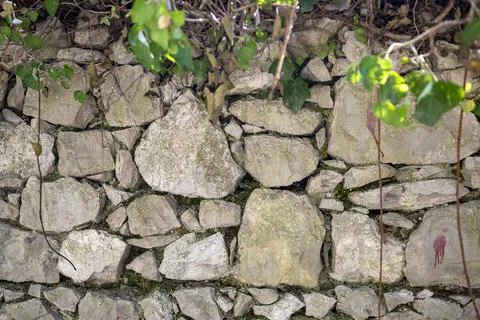 Stone wall background texture. Building facade, High fence made of stone bloc Stock Photos