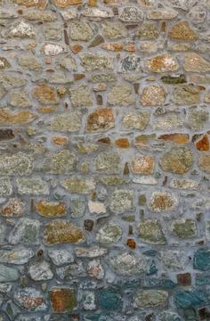 Stone wall with a beautiful array of colors reflecting light during a sunny.. Stock Photos